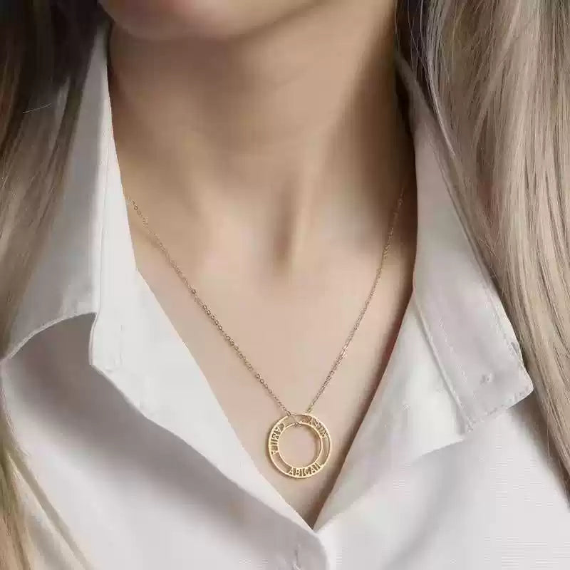Gold necklace with a circular pendant worn by a person in a white shirt. Stainless Steel Name Jewelry. Custom Gift-Personalized. gift for boyfriend / girlfriend. long-distance relationship gift meaningful keepsake. Memory gift. Christmas couple gift. Birthday Gift. Bubble Name Necklace