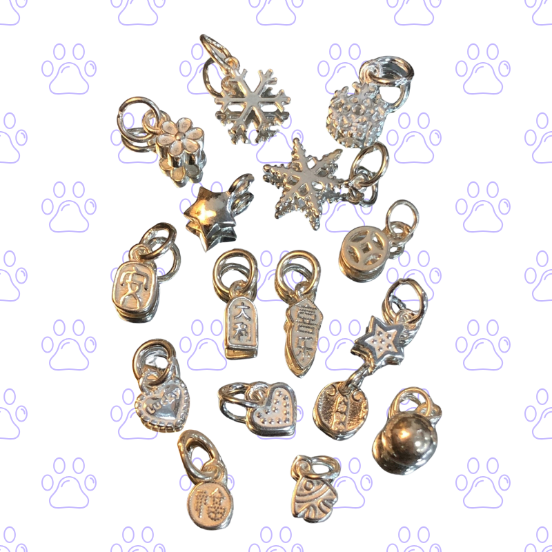 Collection of various silver and gold charms on a white background with paw prints. custom bracelet, pet jewerly, memory gift