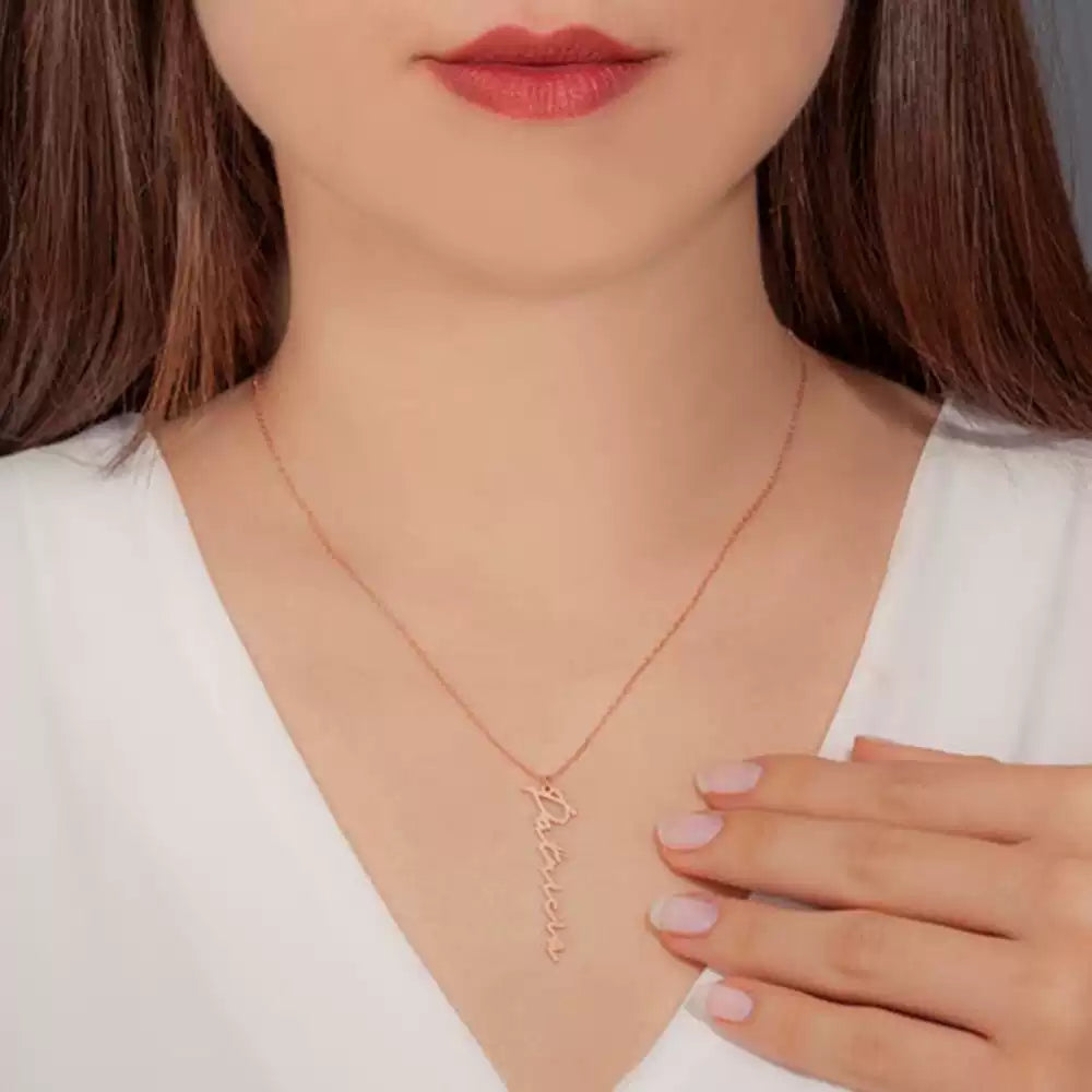 Rose gold necklace with name pendant worn by a person Stainless Steel Name Jewelry. Custom Gift-Personalized. gift for boyfriend / girlfriend. long-distance relationship gift meaningful keepsake. Memory gift. Christmas couple gift. Birthday Gift. Vertical Name Necklace