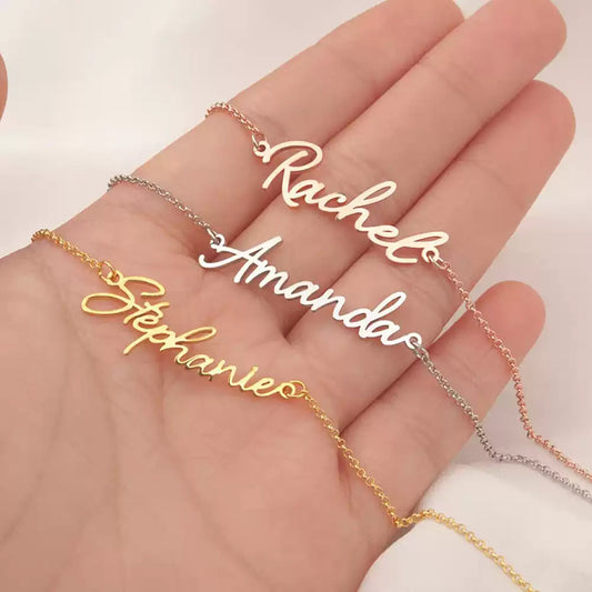 Three name necklaces on a hand with 'Rachela', 'Amanda', and 'Stephanie' inscribed. Stainless Steel Name Jewelry. Custom Gift-Personalized. gift for boyfriend / girlfriend. long-distance relationship gift meaningful keepsake. Memory gift. Christmas couple gift. Birthday Gift.