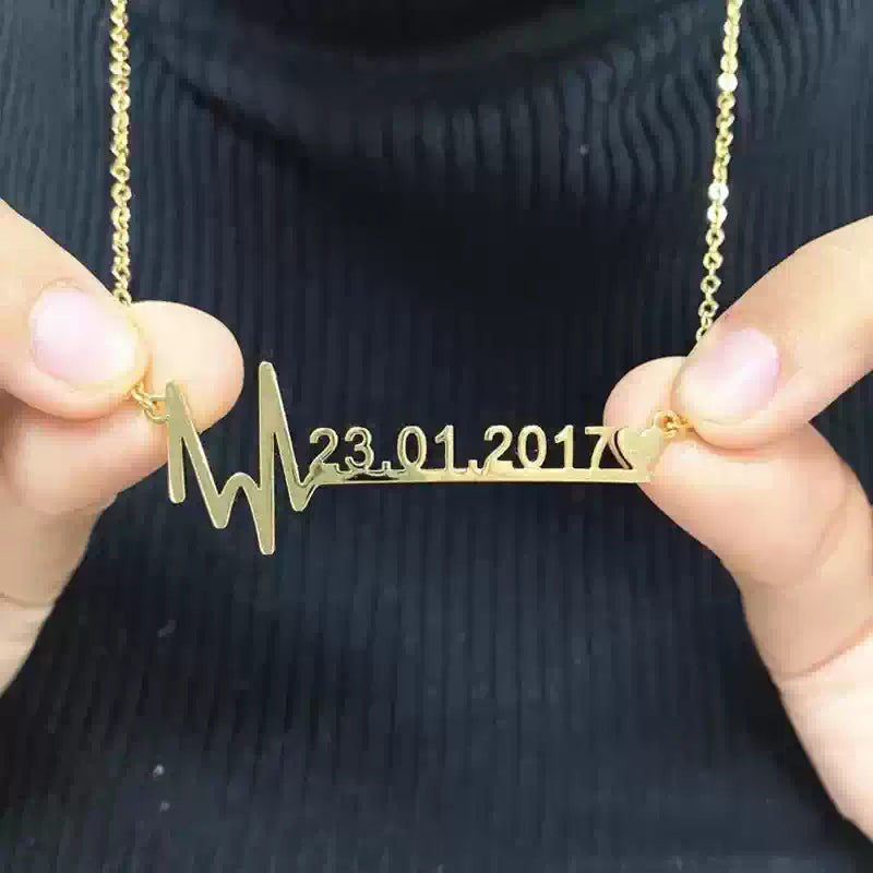 Gold necklace with a unique design held by hands against a dark . Stainless Steel Name Jewelry. Custom Gift-Personalized. gift for boyfriend / girlfriend. long-distance relationship gift meaningful keepsake. Memory gift. Christmas couple gift. Birthday Gift. Wave Chain Name Necklacebackground