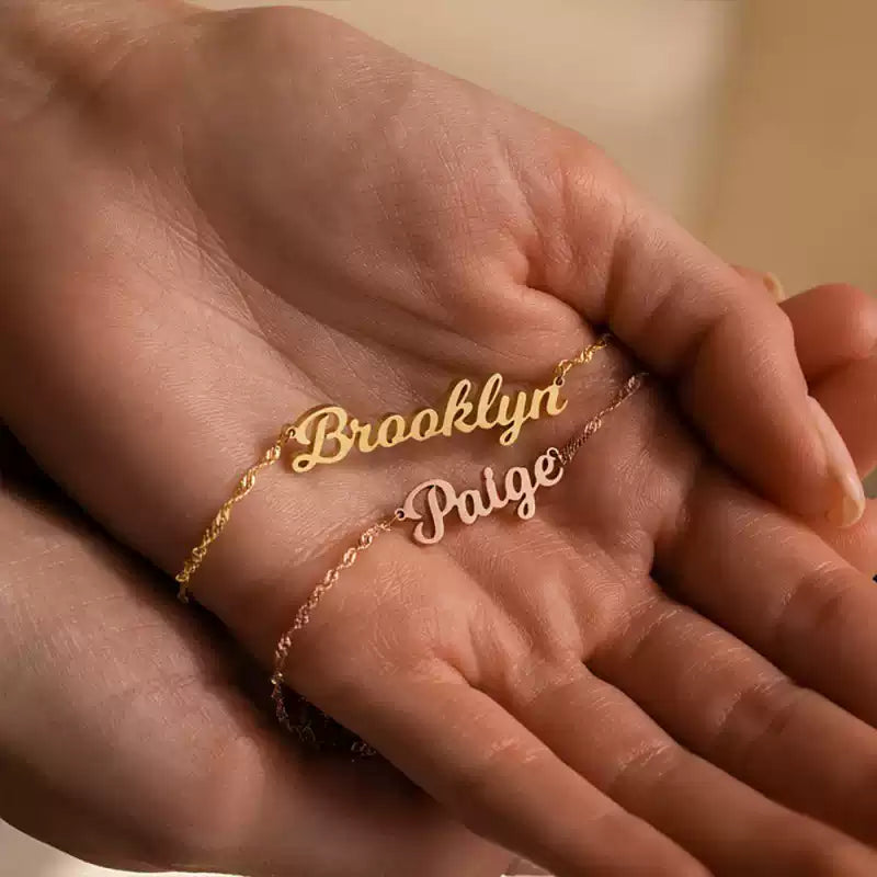 Gold name bracelet on a hand with a blurred background. Stainless Steel Name Jewelry. Custom Gift-Personalized. gift for boyfriend / girlfriend. long-distance relationship gift meaningful keepsake. Memory gift. Christmas couple gift. Birthday Gift. Wave Chain Name Necklace