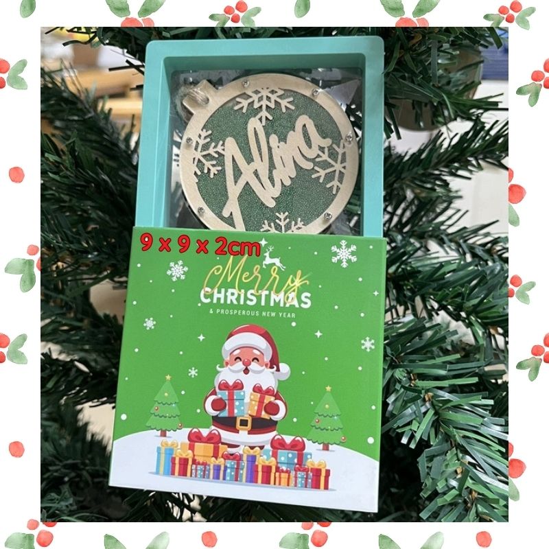 Christmas-themed packaging with a decorative ornament on a Christmas tree background