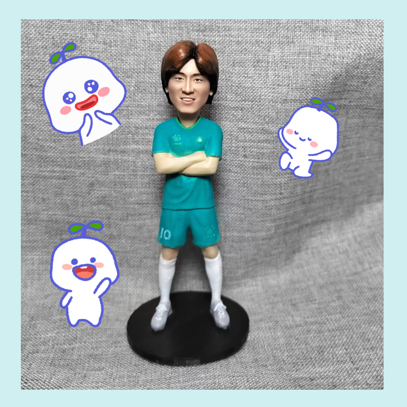 Figurine of a person in teal sports uniform with cartoon characters on a textured gray background. Personalized couple present. Gift for boyfriend girlfriend. Custom-made. Personalized. Perfect gift idea. Meaningful keepsake. Wedding gift. Anniversary gift. Birthday gift