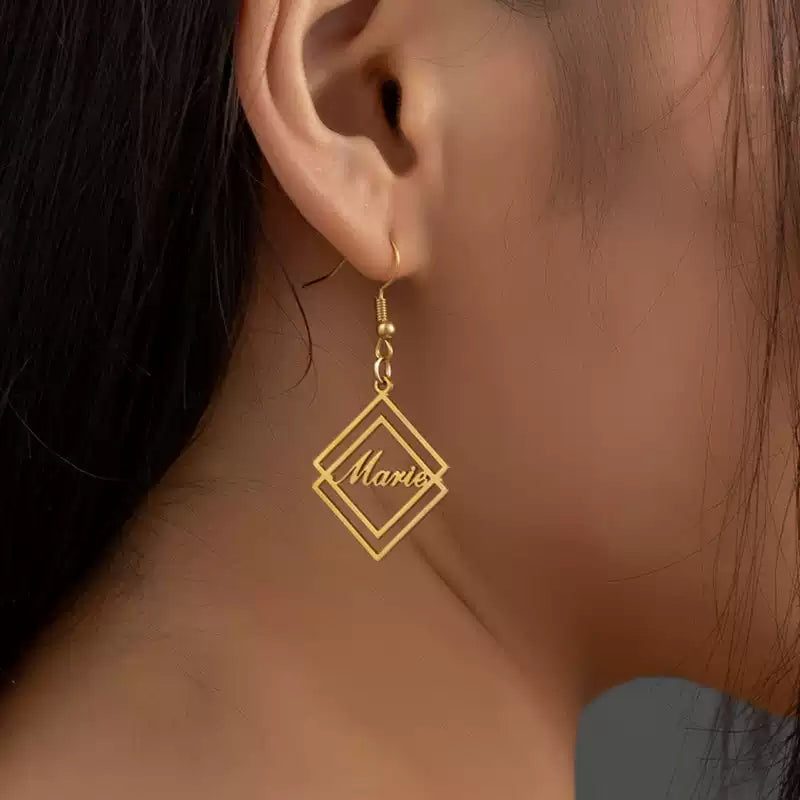 Gold earrings with 'Maria' inscription worn by a person Stainless Steel Name Jewelry. Custom Gift-Personalized. gift for boyfriend / girlfriend. long-distance relationship gift meaningful keepsake. Memory gift. Christmas couple gift. Birthday Gift. Geometric Stack Hook Earrings