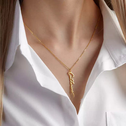 Gold necklace with 'Catherine' pendant on a white shirt Stainless Steel Name Jewelry. Custom Gift-Personalized. gift for boyfriend / girlfriend. long-distance relationship gift meaningful keepsake. Memory gift. Christmas couple gift. Birthday Gift. Vertical Name Necklace