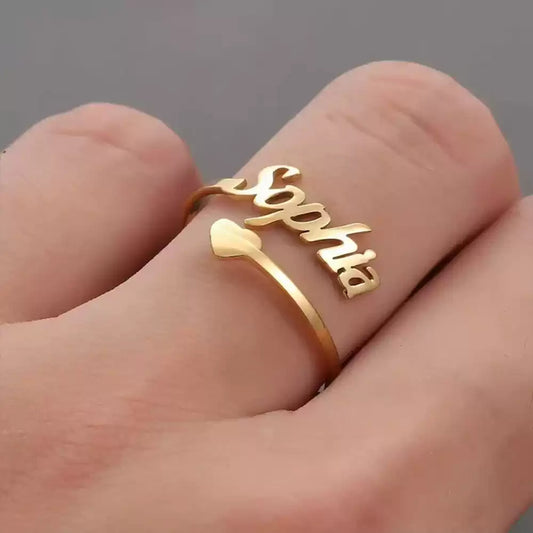 Gold ring with 'Sophia' on a finger against a gray background. Stainless Steel Name Jewelry. Custom Gift-Personalized. gift for boyfriend / girlfriend. long-distance relationship gift meaningful keepsake. Memory gift. Christmas couple gift. Birthday Gift. 
