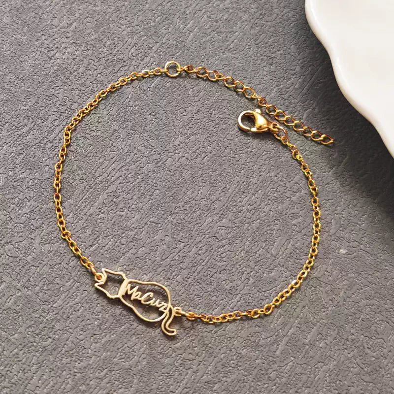Gold bracelet with a name charm on a gray surface. Cat with name. Stainless Steel Name Jewelry. Custom Gift-Personalized. gift for boyfriend / girlfriend. long-distance relationship gift meaningful keepsake. Memory gift. Christmas couple gift. Birthday Gift. 
