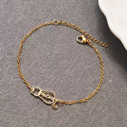 Gold bracelet with a name charm on a gray surface. Cat with name. Stainless Steel Name Jewelry. Custom Gift-Personalized. gift for boyfriend / girlfriend. long-distance relationship gift meaningful keepsake. Memory gift. Christmas couple gift. Birthday Gift. 