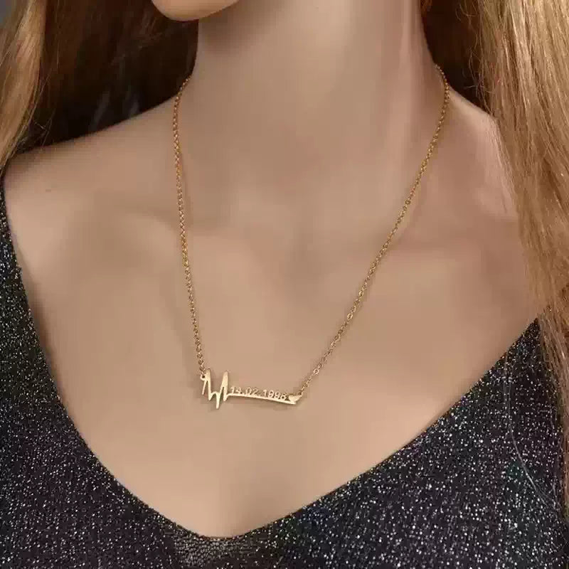 Gold necklace with a pendant on a mannequin wearing a black glittery top.. Stainless Steel Name Jewelry. Custom Gift-Personalized. gift for boyfriend / girlfriend. long-distance relationship gift meaningful keepsake. Memory gift. Christmas couple gift. Birthday Gift. Wave Chain Name Necklace