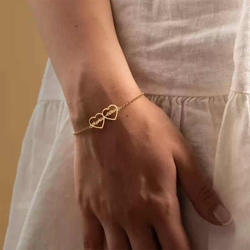 Gold bracelet with heart design on a wrist against a neutral background. Double heart. Stainless Steel Name Jewelry. Custom Gift-Personalized. gift for boyfriend / girlfriend. long-distance relationship gift meaningful keepsake. Memory gift. Christmas couple gift. Birthday Gift. 
