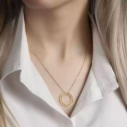 Gold necklace with a circular pendant worn by a person in a white shirt. Stainless Steel Name Jewelry. Custom Gift-Personalized. gift for boyfriend / girlfriend. long-distance relationship gift meaningful keepsake. Memory gift. Christmas couple gift. Birthday Gift. Bubble Name Necklace