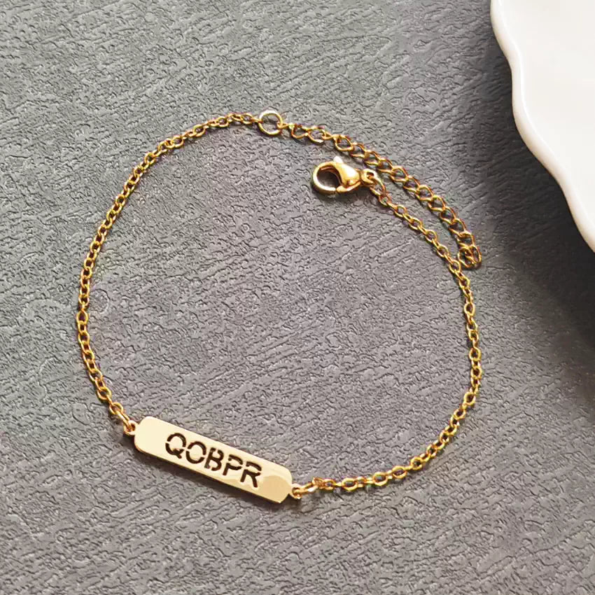Gold bracelet with a bar charm on a gray surface. Hollow Plaque. Stainless Steel Name Jewelry. Custom Gift-Personalized. gift for boyfriend / girlfriend. long-distance relationship gift meaningful keepsake. Memory gift. Christmas couple gift. Birthday Gift. 