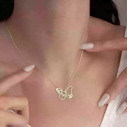 Butterfly-shaped necklace with 'Bella' on a person's neck against a pink background Stainless Steel Name Jewelry. Custom Gift-Personalized. gift for boyfriend / girlfriend. long-distance relationship gift meaningful keepsake. Memory gift. Christmas couple gift. Birthday Gift. Butterfly & Blossom Name Necklace