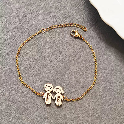 Gold bracelet with two small figures holding hands on a gray surface. Boy & Girl holding hands. Stainless Steel Name Jewelry. Custom Gift-Personalized. gift for boyfriend / girlfriend. long-distance relationship gift meaningful keepsake. Memory gift. Christmas couple gift. Birthday Gift. 