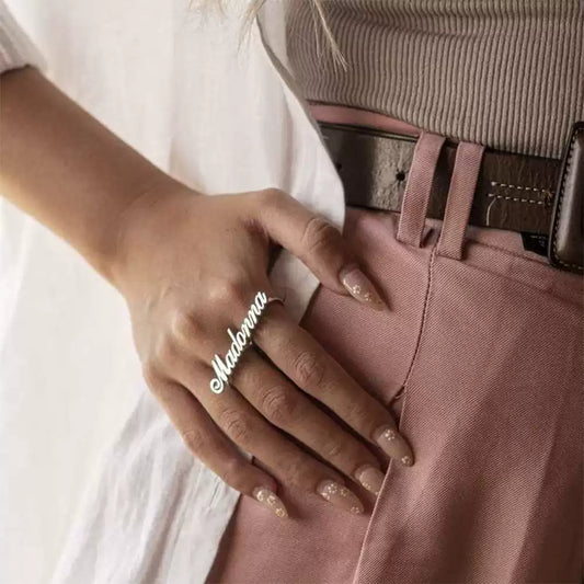 Hand wearing a ring with 'Madonna' on a light background. Double hole rings. Stainless Steel Name Jewelry. Custom Gift-Personalized. gift for boyfriend / girlfriend. long-distance relationship gift meaningful keepsake. Memory gift. Christmas couple gift. Birthday Gift. 