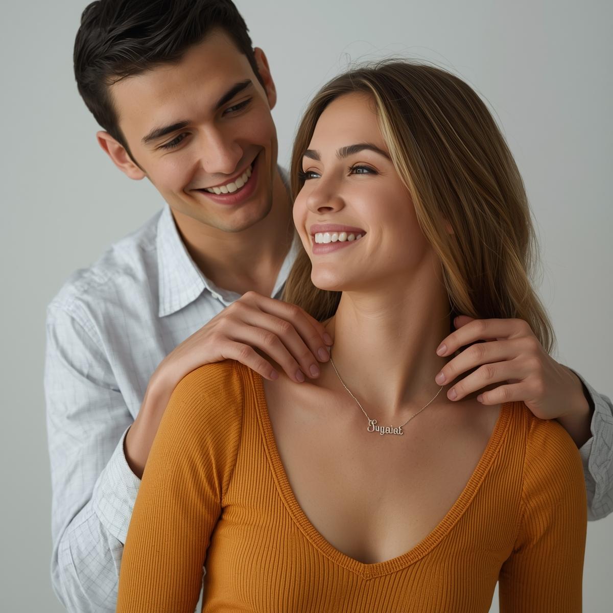 Man and woman smiling, with a focus on the woman wearing a necklace.