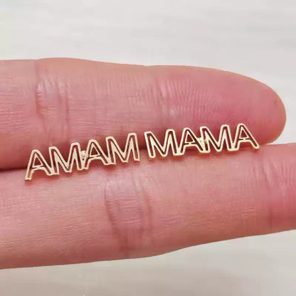 Gold 'AMAM MAMA' necklace on a finger against a white background Stainless Steel Name Jewelry. Custom Gift-Personalized. gift for boyfriend / girlfriend. long-distance relationship gift meaningful keepsake. Memory gift. Christmas couple gift. Birthday Gift. Hollow Line Name Studs