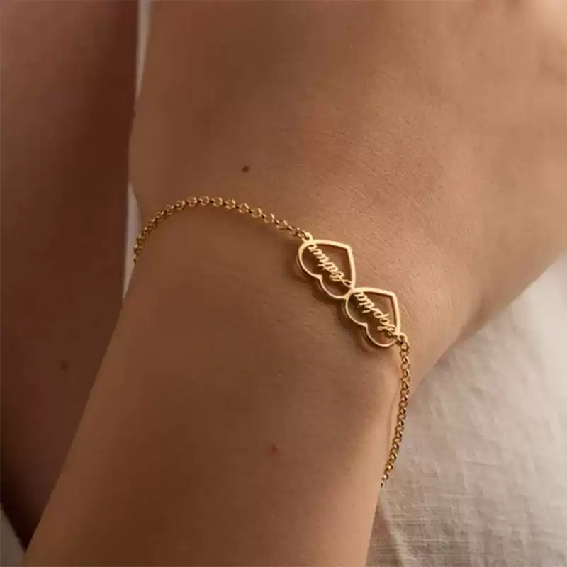 Gold bracelet on a wrist with a blurred background. Double heart. Stainless Steel Name Jewelry. Custom Gift-Personalized. gift for boyfriend / girlfriend. long-distance relationship gift meaningful keepsake. Memory gift. Christmas couple gift. Birthday Gift. 