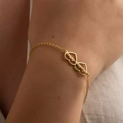 Gold bracelet on a wrist with a blurred background. Double heart. Stainless Steel Name Jewelry. Custom Gift-Personalized. gift for boyfriend / girlfriend. long-distance relationship gift meaningful keepsake. Memory gift. Christmas couple gift. Birthday Gift. 