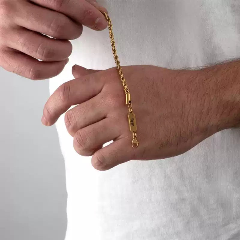 Gold bracelet being adjusted on a wrist against a plain background. Rope chain. Stainless Steel Name Jewelry. Custom Gift-Personalized. gift for boyfriend / girlfriend. long-distance relationship gift meaningful keepsake. Memory gift. Christmas couple gift. Birthday Gift. 