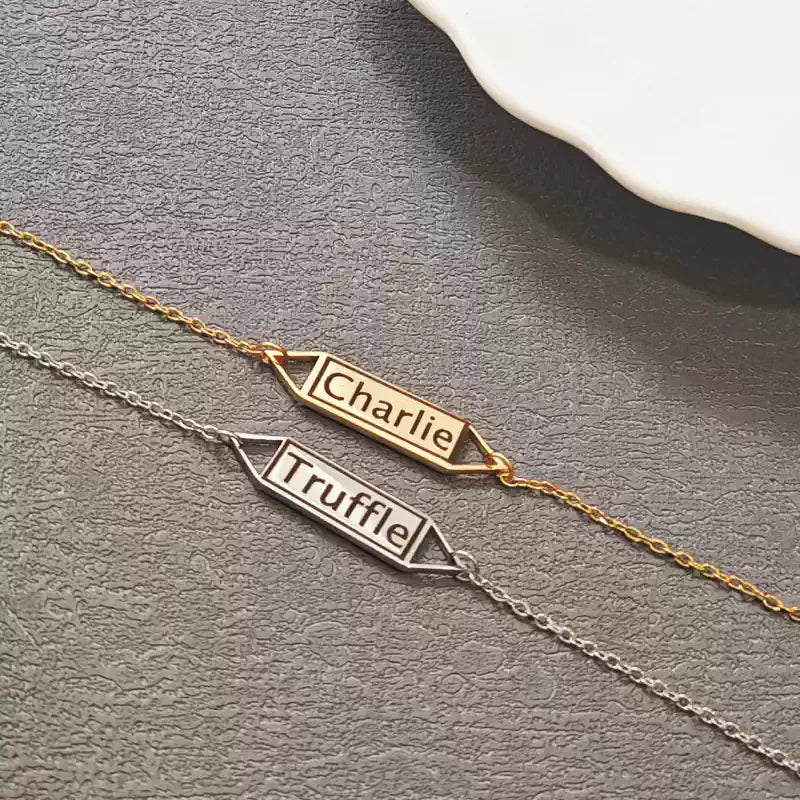 Two name bracelets, one gold and one silver, on a gray surface. Hollow Plaque. Stainless Steel Name Jewelry. Custom Gift-Personalized. gift for boyfriend / girlfriend. long-distance relationship gift meaningful keepsake. Memory gift. Christmas couple gift. Birthday Gift. 