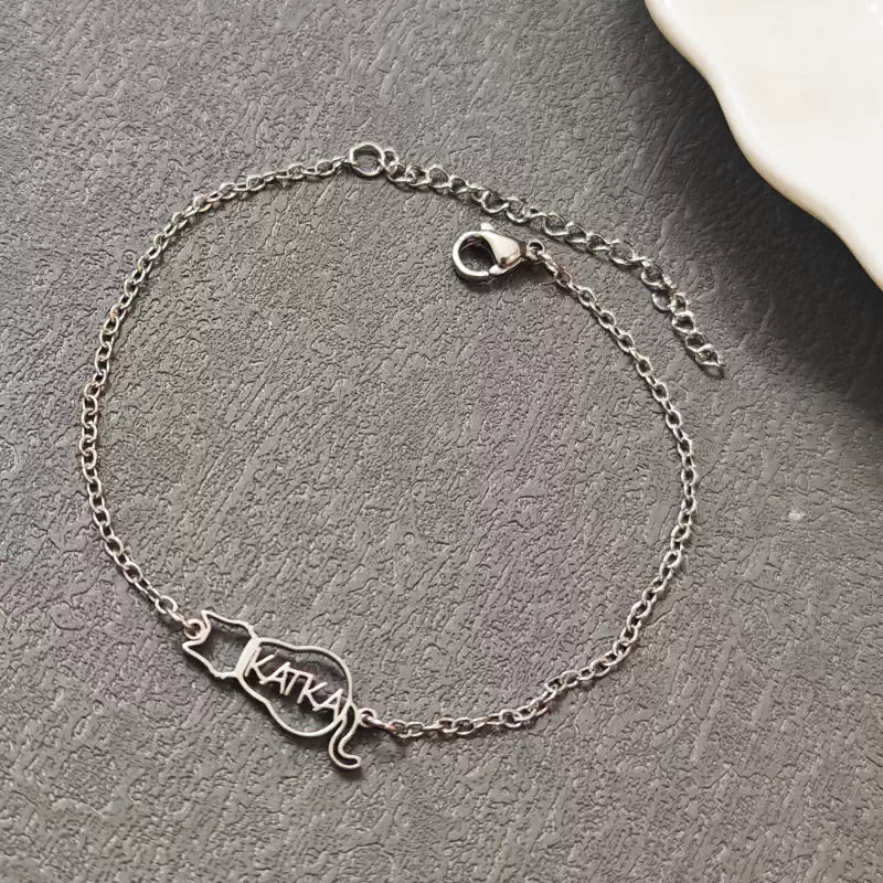 Silver bracelet with 'Katka' charm on a gray surface. Cat with name. Stainless Steel Name Jewelry. Custom Gift-Personalized. gift for boyfriend / girlfriend. long-distance relationship gift meaningful keepsake. Memory gift. Christmas couple gift. Birthday Gift. 