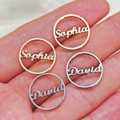 Gold and silver name charms on a hand Stainless Steel Name Jewelry. Custom Gift-Personalized. gift for boyfriend / girlfriend. long-distance relationship gift meaningful keepsake. Memory gift. Christmas couple gift. Birthday Gift. Circle Charm Name Earrings
