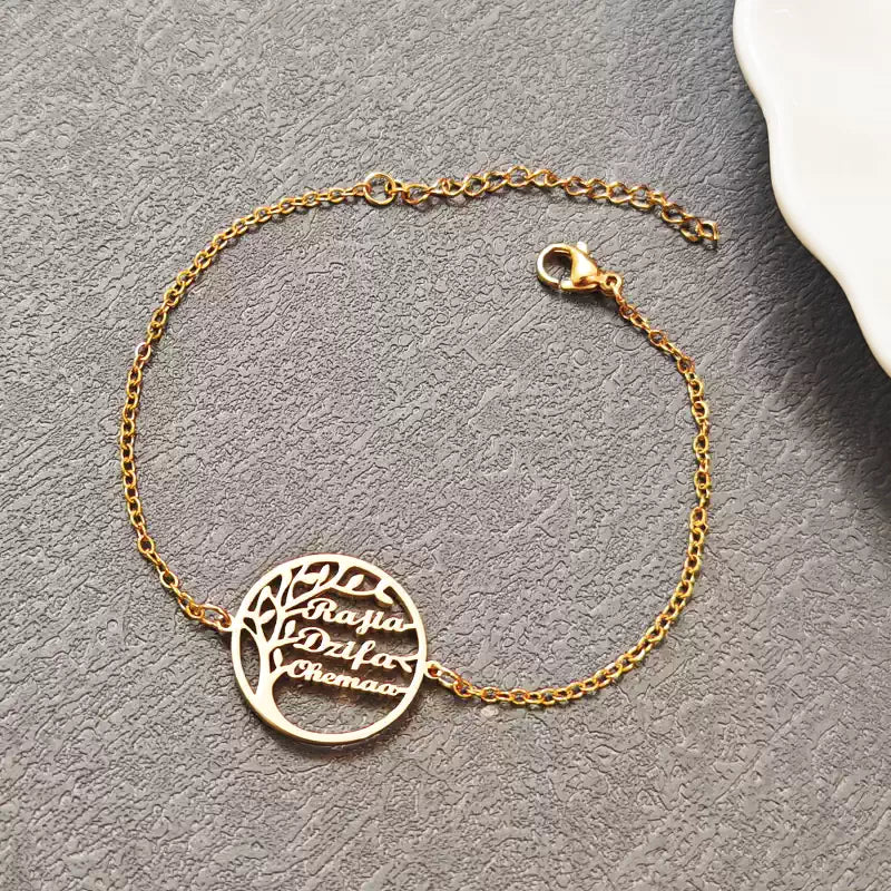 Gold bracelet with a tree-shaped charm on a gray surface. Stainless Steel Name Jewelry. Custom Gift-Personalized. gift for boyfriend / girlfriend. long-distance relationship gift meaningful keepsake. Memory gift. Christmas couple gift. Birthday Gift. 