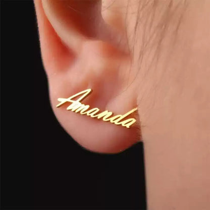 Gold 'Amanda' earring on a person's ear with a black background Stainless Steel Name Jewelry. Custom Gift-Personalized. gift for boyfriend / girlfriend. long-distance relationship gift meaningful keepsake. Memory gift. Christmas couple gift. Birthday Gift. Curved SoulName Earrings