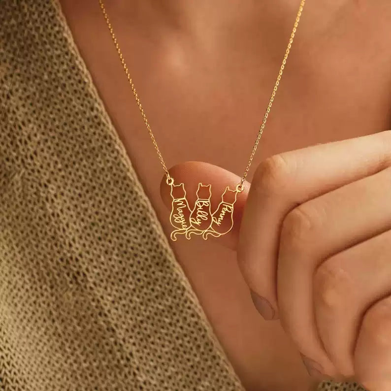 Gold necklace with a cat-themed pendant on a person's neck. Baby Cat Necklace. 