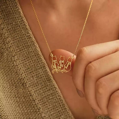 Gold necklace with a cat-themed pendant on a person's neck. Baby Cat Necklace. 