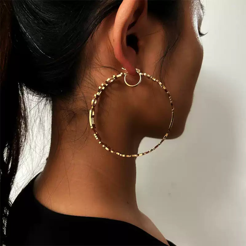 Gold hoop earring worn by a person with a neutral background Stainless Steel Name Jewelry. Custom Gift-Personalized. gift for boyfriend / girlfriend. long-distance relationship gift meaningful keepsake. Memory gift. Christmas couple gift. Birthday Gift. Statement Loop Name Earrings