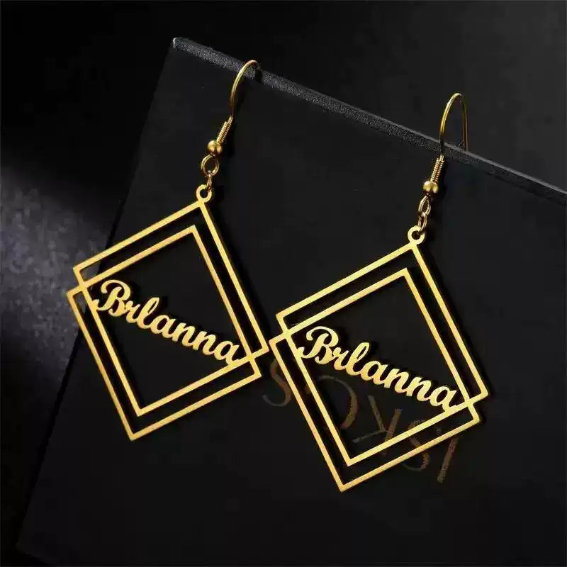 Gold square-shaped earrings with 'Brianna' engraving on a black background Stainless Steel Name Jewelry. Custom Gift-Personalized. gift for boyfriend / girlfriend. long-distance relationship gift meaningful keepsake. Memory gift. Christmas couple gift. Birthday Gift. Geometric Stack Hook Earrings