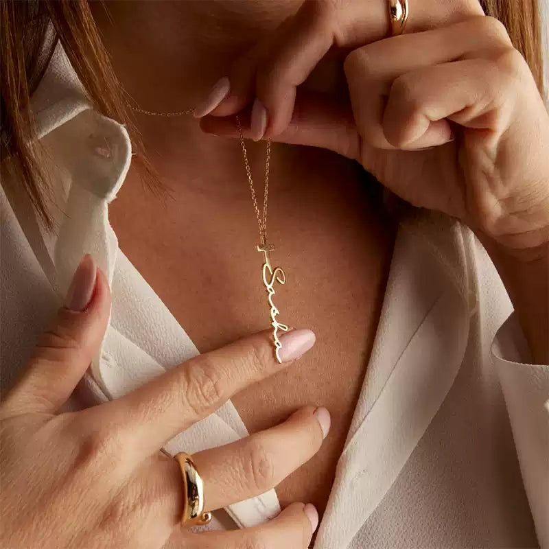 Person wearing a gold necklace with a delicate chain design, held by another hand. . Stainless Steel Name Jewelry. Custom Gift-Personalized. gift for boyfriend / girlfriend. long-distance relationship gift meaningful keepsake. Memory gift. Christmas couple gift. Birthday Gift. Cross Name Necklace
