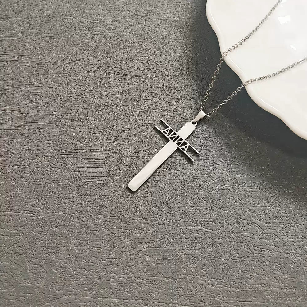 Silver cross necklace on a textured gray surface Stainless Steel Name Jewelry. Custom Gift-Personalized. gift for boyfriend / girlfriend. long-distance relationship gift meaningful keepsake. Memory gift. Christmas couple gift. Birthday Gift. Hollow Letter Cross Necklace