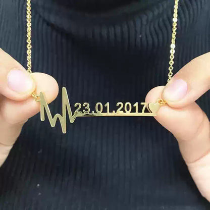 Gold necklace with a unique design held by hands against a dark . Stainless Steel Name Jewelry. Custom Gift-Personalized. gift for boyfriend / girlfriend. long-distance relationship gift meaningful keepsake. Memory gift. Christmas couple gift. Birthday Gift. Wave Chain Name Necklacebackground