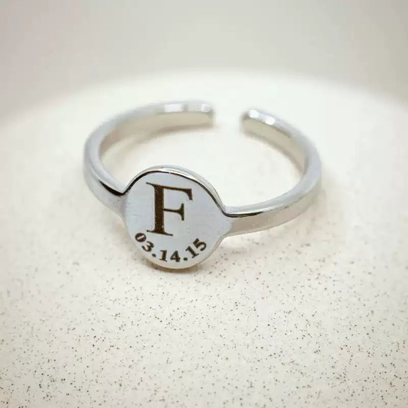 Silver ring with engraved letter 'F' and date on a light background. Stainless Steel Name Jewelry. Custom Gift-Personalized. gift for boyfriend / girlfriend. long-distance relationship gift meaningful keepsake. Memory gift. Christmas couple gift. Birthday Gift. Circle of Memories. 