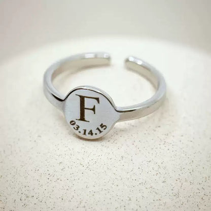 Silver ring with engraved letter 'F' and date on a light background. Stainless Steel Name Jewelry. Custom Gift-Personalized. gift for boyfriend / girlfriend. long-distance relationship gift meaningful keepsake. Memory gift. Christmas couple gift. Birthday Gift. Circle of Memories. 