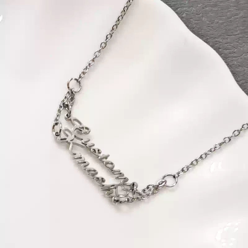Silver necklace on a white cushion with a gray background. Stainless Steel Name Jewelry. Custom Gift-Personalized. gift for boyfriend / girlfriend. long-distance relationship gift meaningful keepsake. Memory gift. Christmas couple gift. Birthday Gift. 