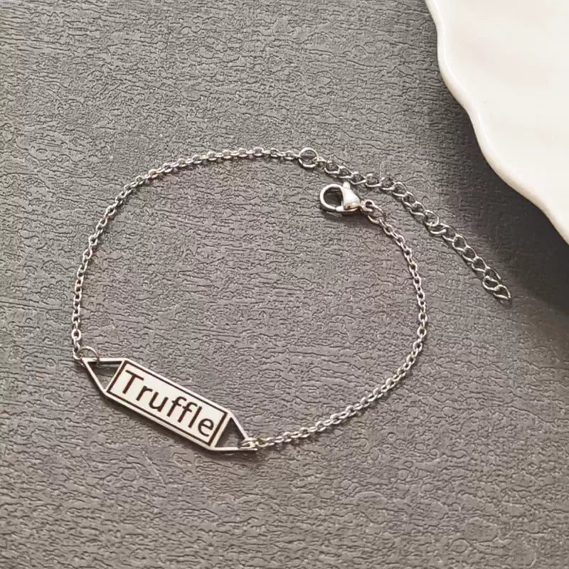 Silver bracelet with 'Truffle' tag on a gray surface. Hollow Plaque. Stainless Steel Name Jewelry. Custom Gift-Personalized. gift for boyfriend / girlfriend. long-distance relationship gift meaningful keepsake. Memory gift. Christmas couple gift. Birthday Gift. 