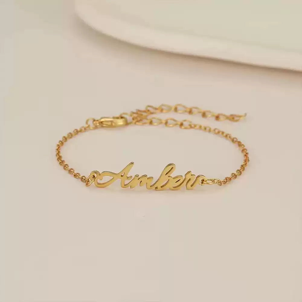 Gold bracelet with 'Amber' engraving on a beige background Stainless Steel Name Jewelry. Custom Gift-Personalized. gift for boyfriend / girlfriend. long-distance relationship gift meaningful keepsake. Memory gift. Christmas couple gift. Birthday Gift. 