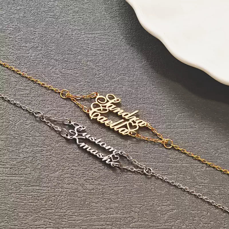 Two gold and silver name necklaces on a gray surface. Stainless Steel Name Jewelry. Custom Gift-Personalized. gift for boyfriend / girlfriend. long-distance relationship gift meaningful keepsake. Memory gift. Christmas couple gift. Birthday Gift. 