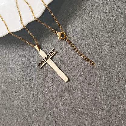 Gold cross necklace with 'Soleone' engraving on a gray surface Stainless Steel Name Jewelry. Custom Gift-Personalized. gift for boyfriend / girlfriend. long-distance relationship gift meaningful keepsake. Memory gift. Christmas couple gift. Birthday Gift. Hollow Letter Cross Necklace