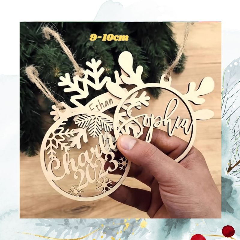 Wooden snowflake-shaped ornament with engraved names and dates, held by a hand against a blurred background.