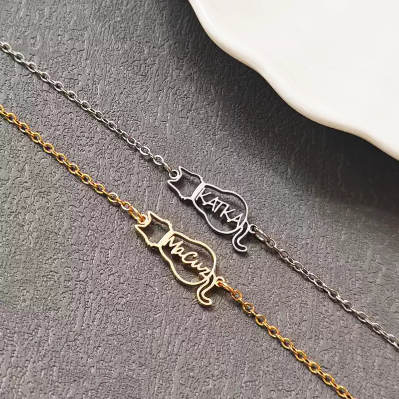 Two cat-shaped nameplates on a chain against a gray background. Cat with name. Stainless Steel Name Jewelry. Custom Gift-Personalized. gift for boyfriend / girlfriend. long-distance relationship gift meaningful keepsake. Memory gift. Christmas couple gift. Birthday Gift. 