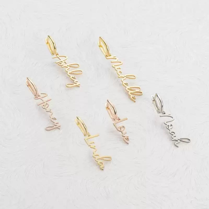 Set of personalized name pendants in gold and silver on a light gray background Stainless Steel Name Jewelry. Custom Gift-Personalized. gift for boyfriend / girlfriend. long-distance relationship gift meaningful keepsake. Memory gift. Christmas couple gift. Birthday Gift. Vertical Charm Ear Cuffs