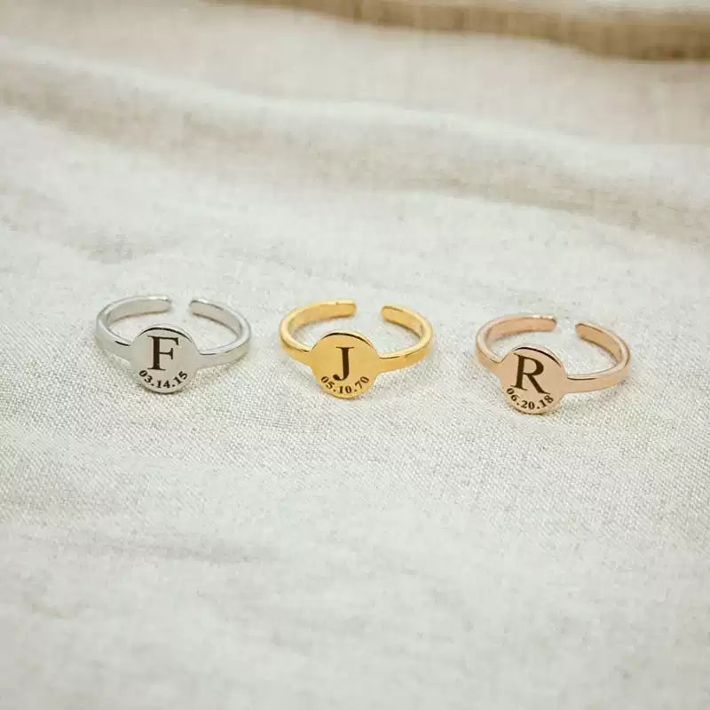 Three open rings with engraved initials on a textured fabric background. Stainless Steel Name Jewelry. Custom Gift-Personalized. gift for boyfriend / girlfriend. long-distance relationship gift meaningful keepsake. Memory gift. Christmas couple gift. Birthday Gift. Circle of Memories. 