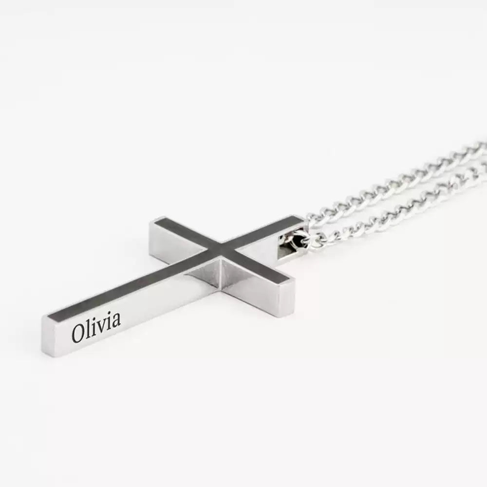 Silver cross-shaped necklace with 'Olivia' engraving on a white background. Stainless Steel Name Jewelry. Custom Gift-Personalized. gift for boyfriend / girlfriend. long-distance relationship gift meaningful keepsake. Memory gift. Christmas couple gift. Birthday Gift. Men’s Black Cross Name Necklace