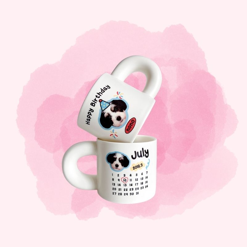 Two white mugs with a dog illustration and text on a pink watercolor background